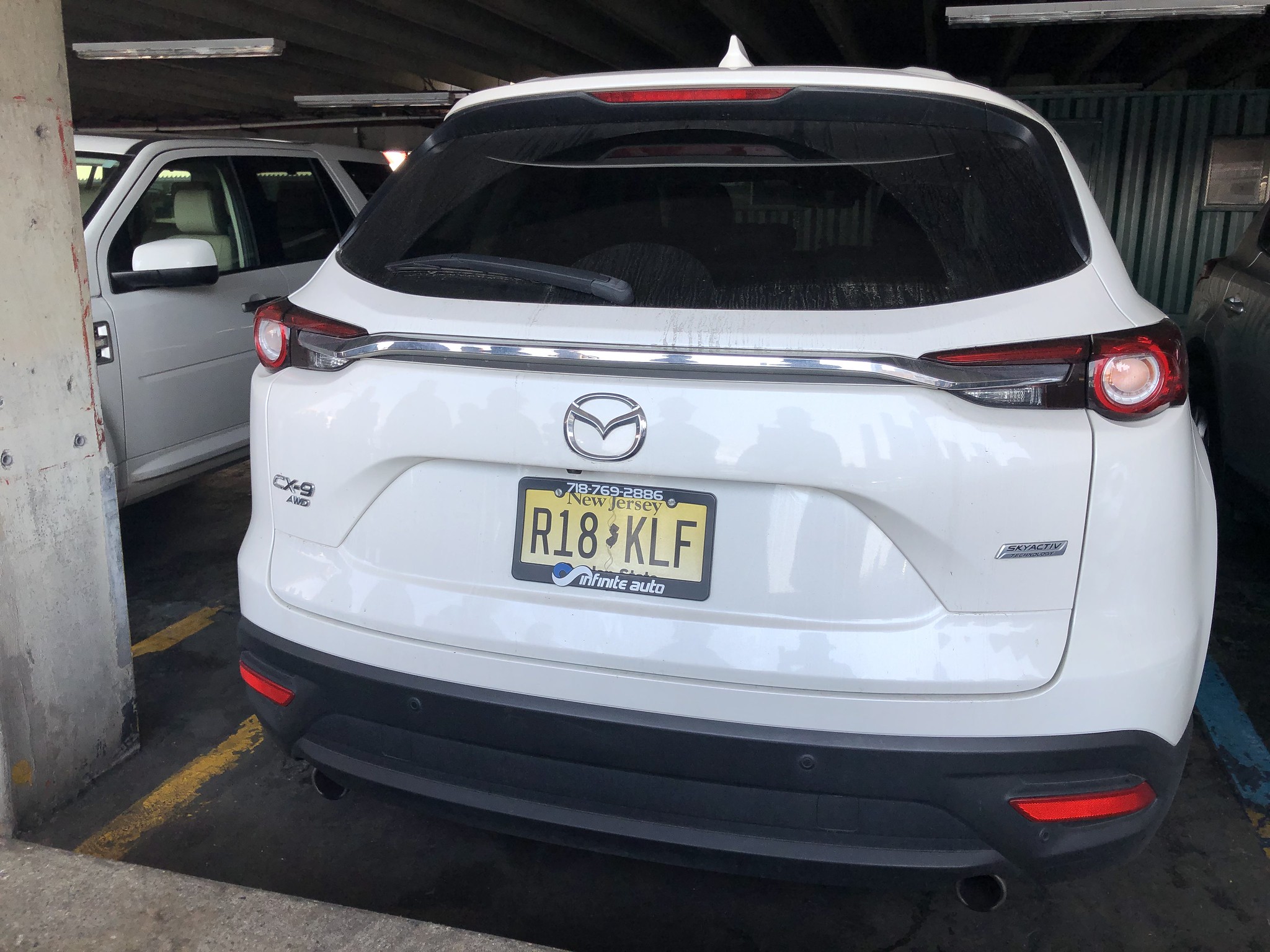 photo of a white Mazda with New Jersey plates R18 KLF
